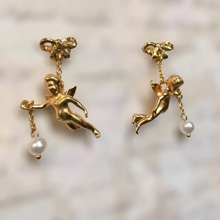 Hoop earrings with artistic filigree designs for an intricate, delicate finish-Flying cherub Pearl Earrings by Bill Skinner