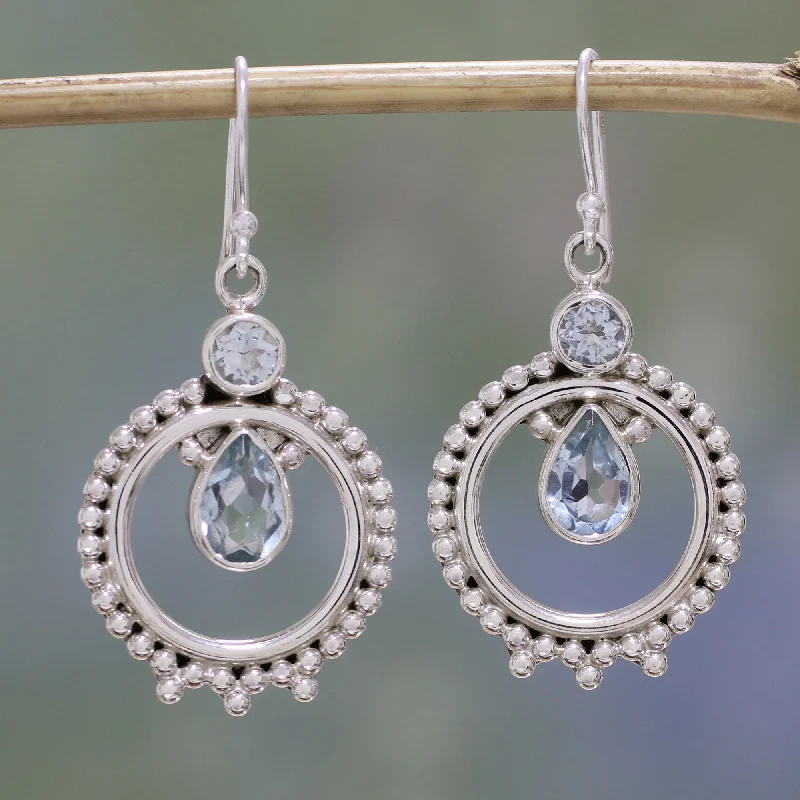 Classic hoop earrings with a thin profile for a sleek and subtle style-Regal Circles Blue Topaz and Sterling Silver Dangle Earrings from India